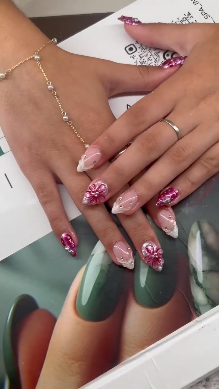 Pink floral almond nails with rhinestone details
