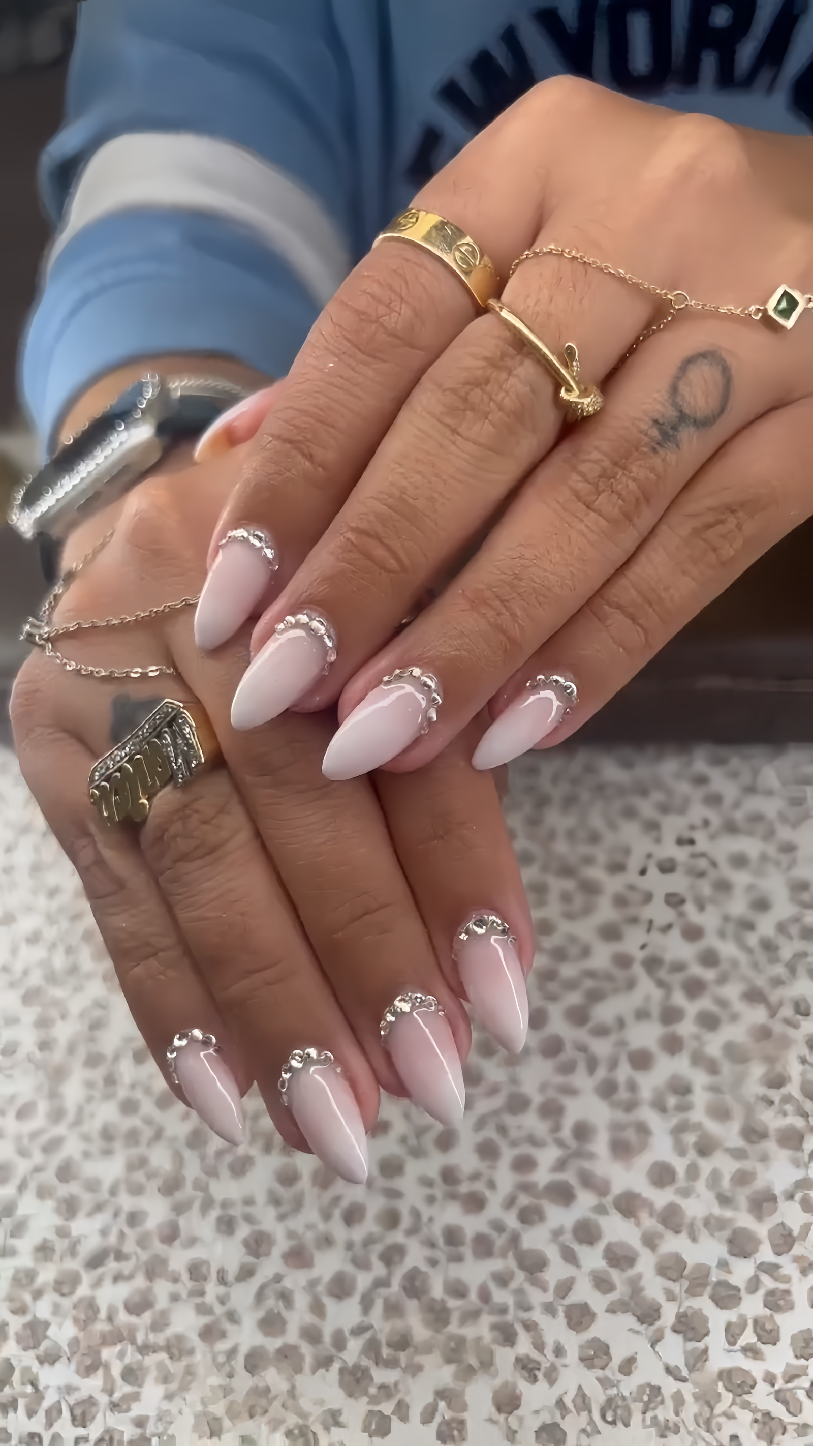 Soft pink almond nails with silver baroque trim